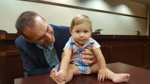 Baby and father at adoption day